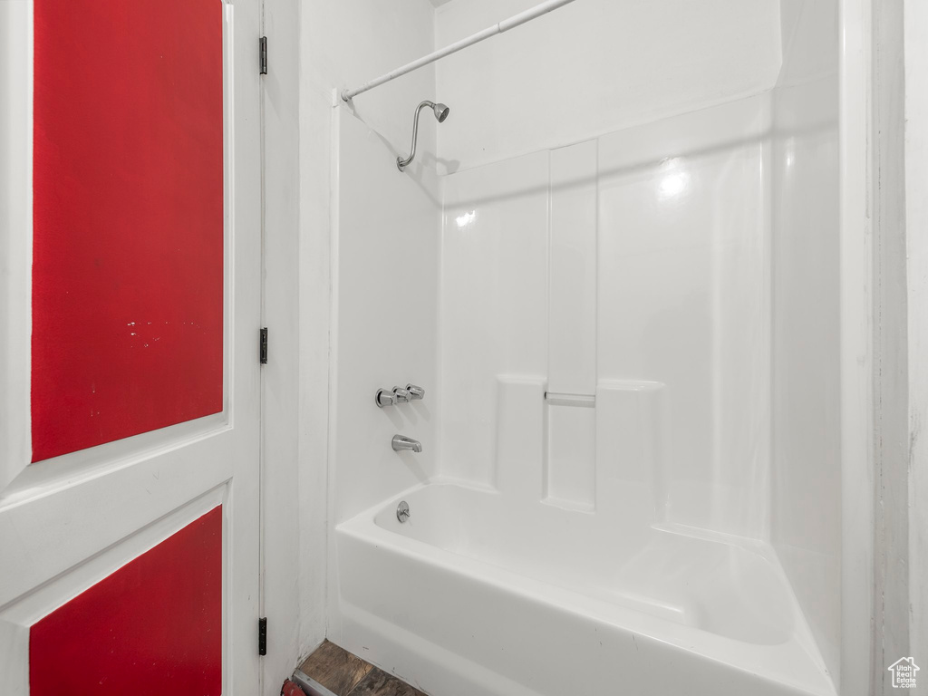 Bathroom featuring wood-type flooring and shower / bathtub combination