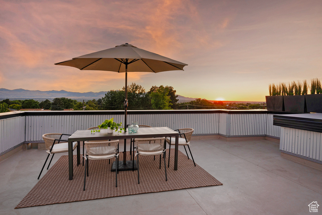 Patio terrace at dusk with a mountain view