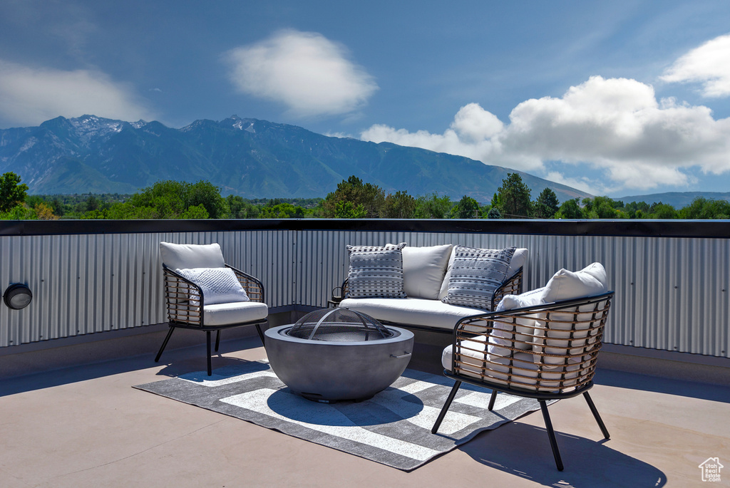 View of patio / terrace with a mountain view and an outdoor fire pit