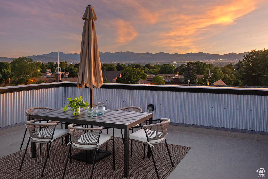 Patio terrace at dusk featuring a mountain view