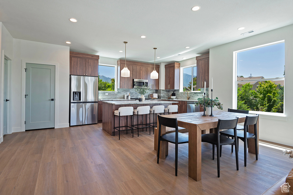 Dining room with hardwood / wood-style flooring and sink