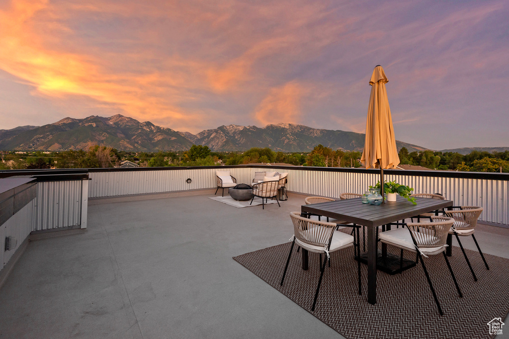 Patio terrace at dusk with a mountain view