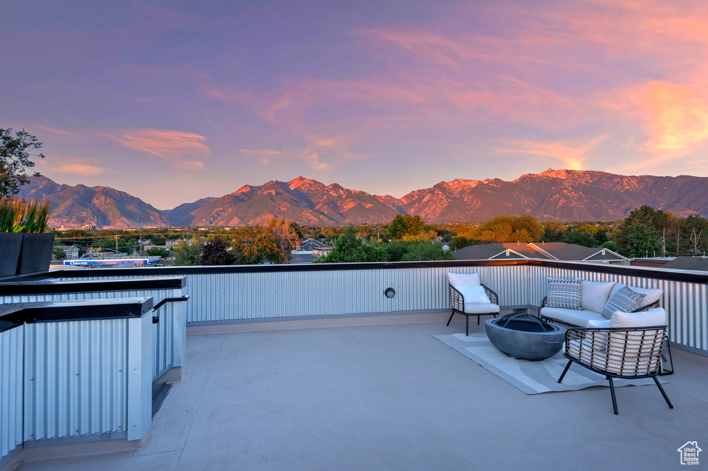 Patio terrace at dusk featuring a mountain view