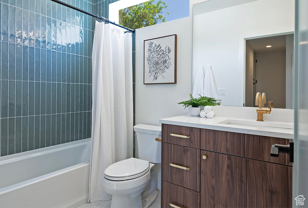 Full bathroom with shower / bath combination with curtain, toilet, and vanity