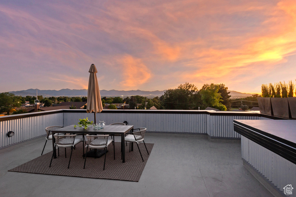 Patio terrace at dusk with a mountain view