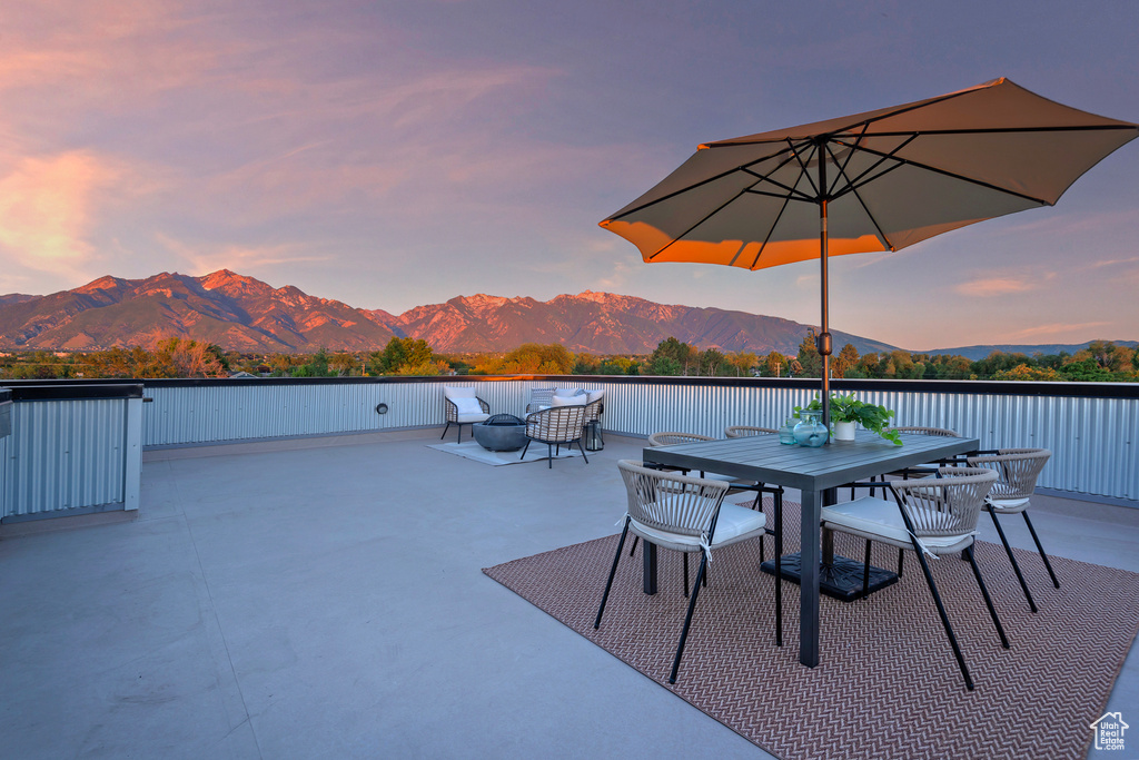 Patio terrace at dusk with a mountain view