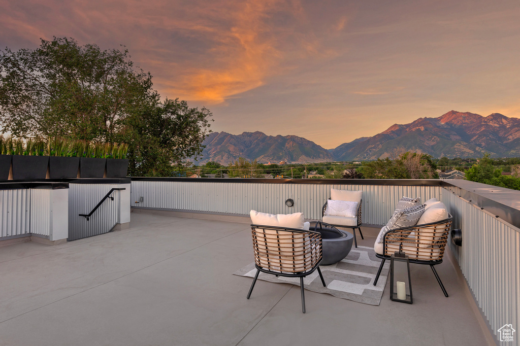 Patio terrace at dusk with a mountain view and outdoor lounge area