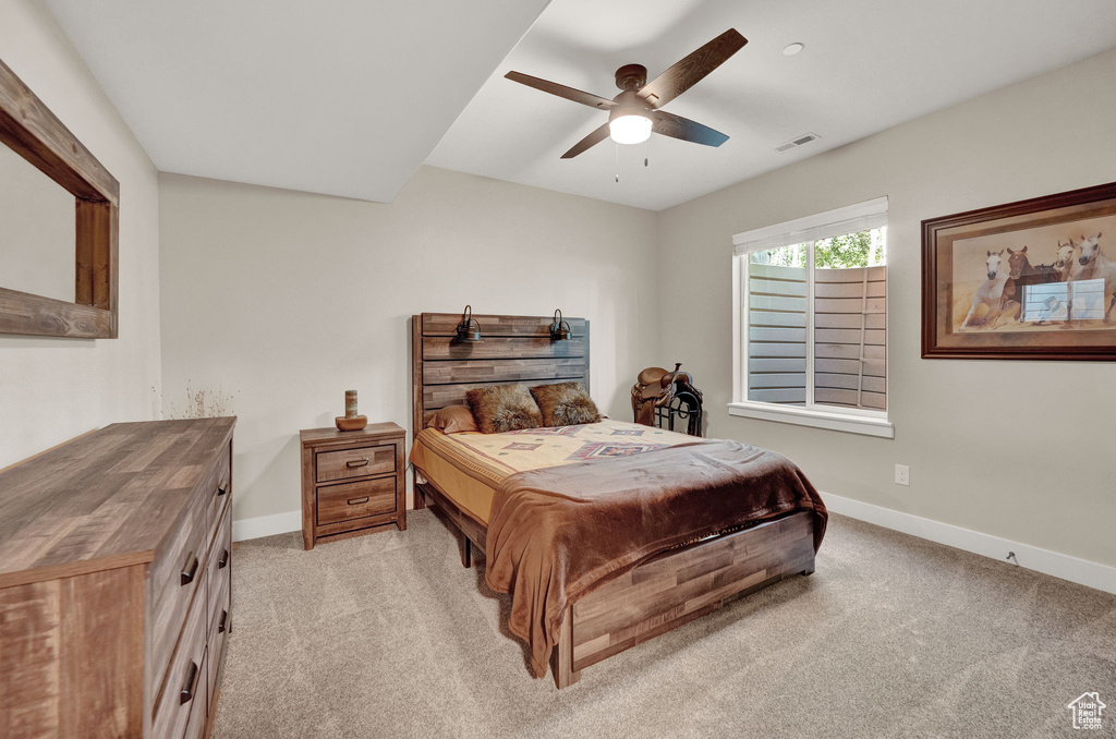 Bedroom with light colored carpet and ceiling fan