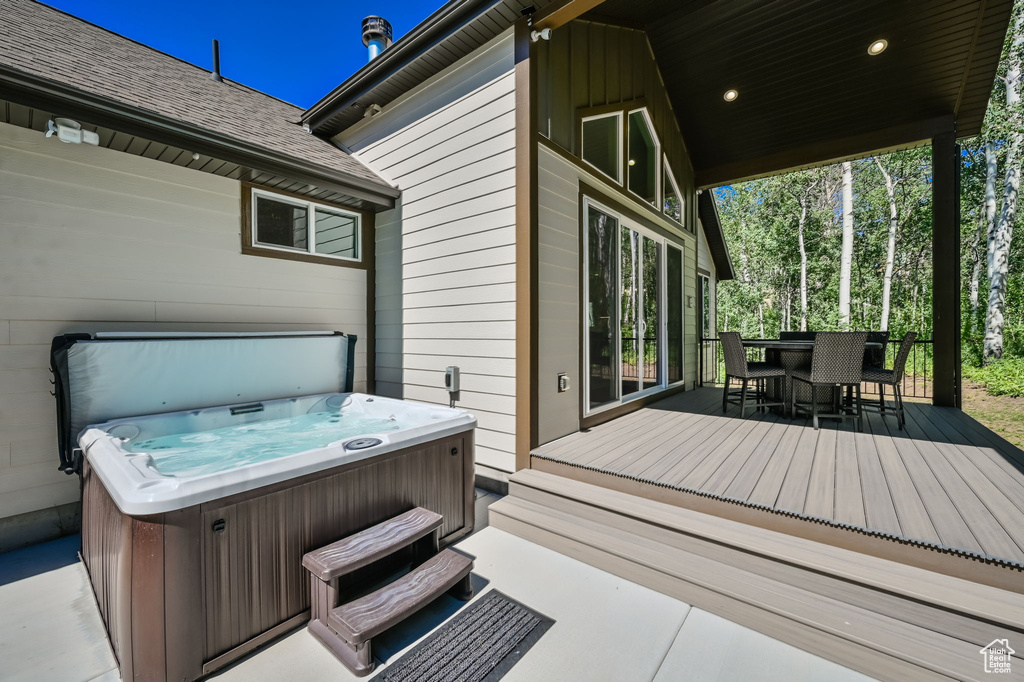 Wooden terrace featuring a hot tub