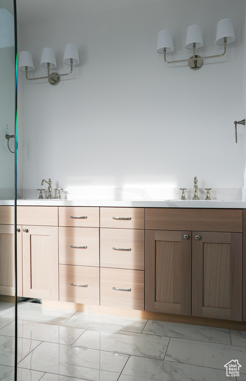 Bathroom featuring vanity and tile patterned flooring