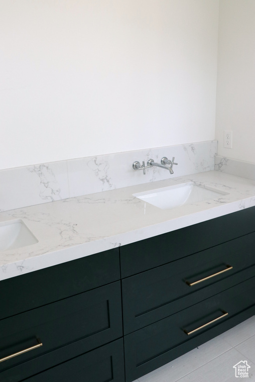 Bathroom featuring vanity and tile patterned flooring