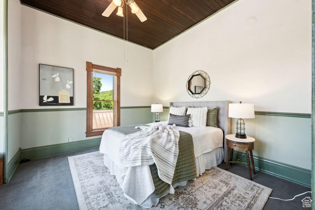 Carpeted bedroom featuring wood ceiling, ceiling fan, and vaulted ceiling