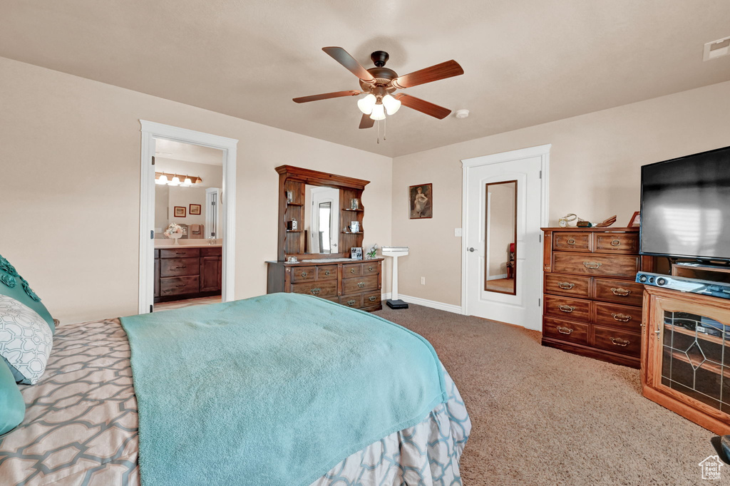 Bedroom featuring ensuite bathroom, carpet, and ceiling fan