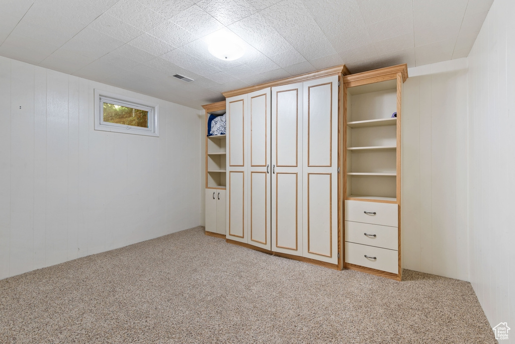 Unfurnished bedroom with light colored carpet