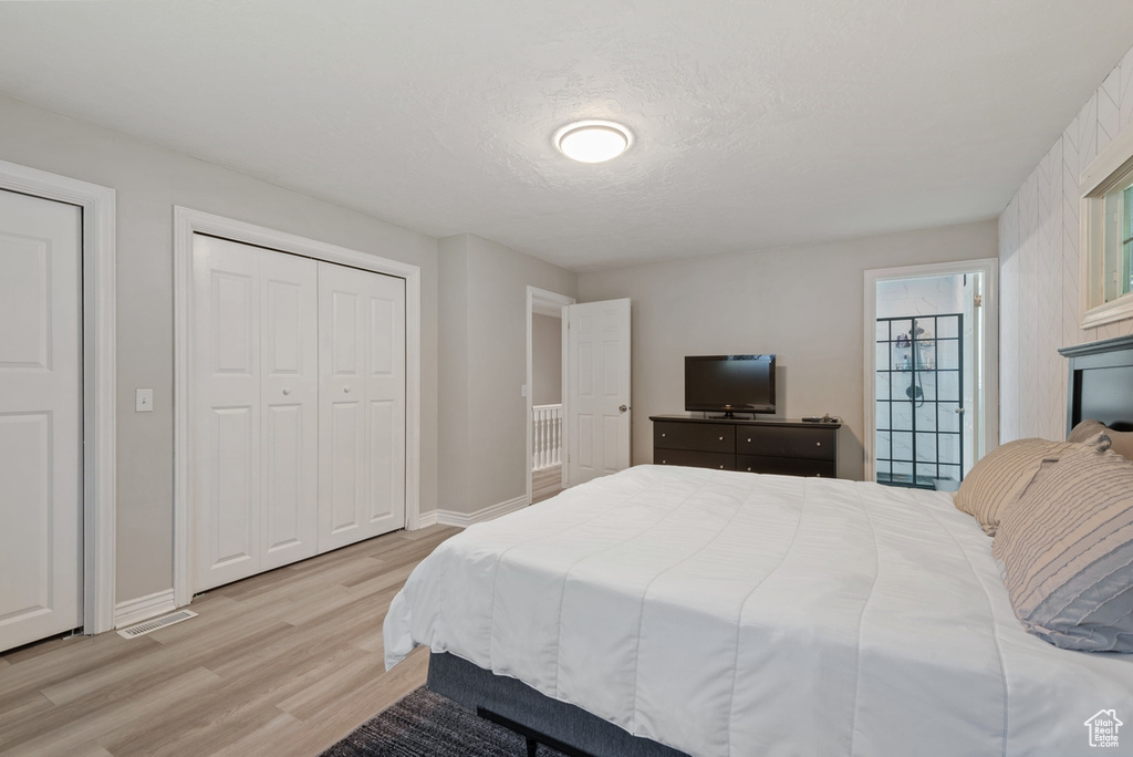 Bedroom with light hardwood / wood-style flooring