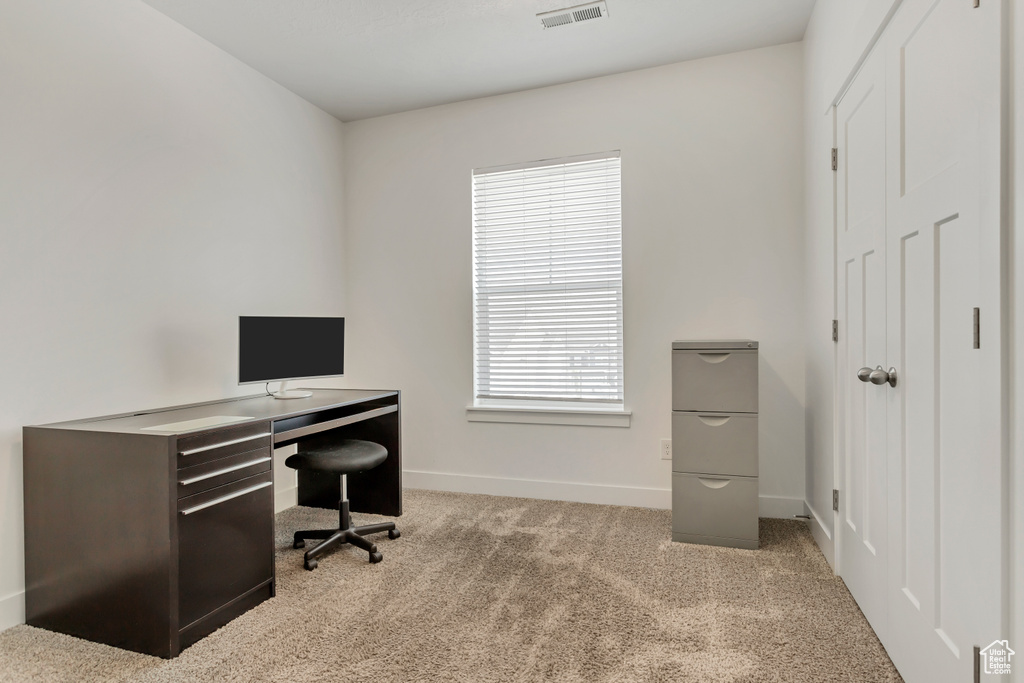 Carpeted office space with plenty of natural light