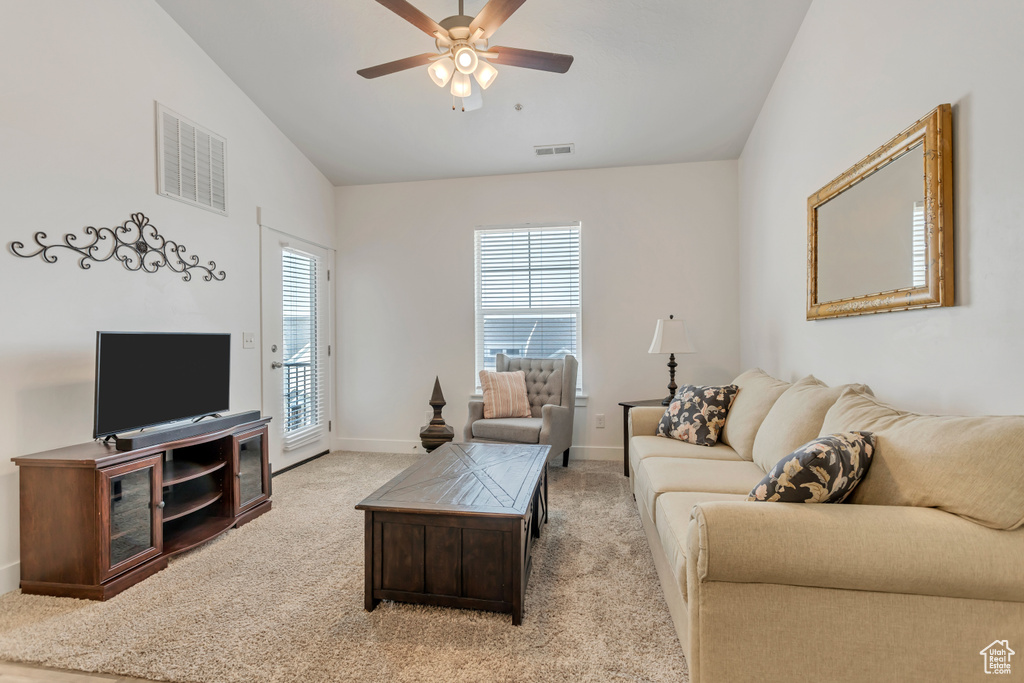 Living room with carpet flooring, ceiling fan, and vaulted ceiling