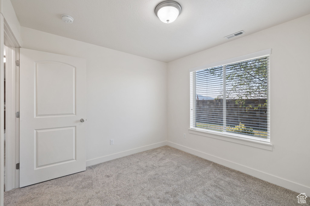 Spare room with light colored carpet