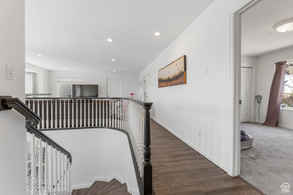 Stairs featuring dark carpet