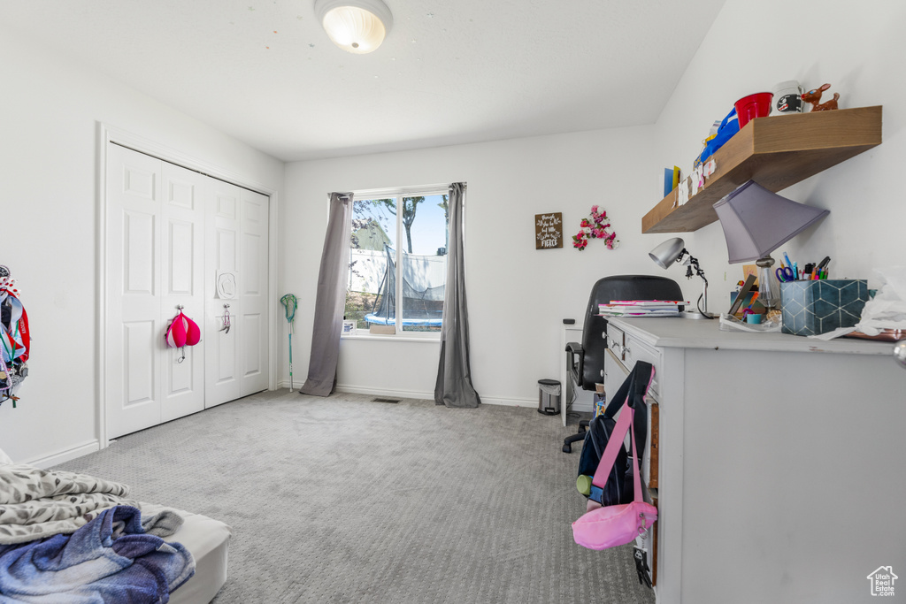 Carpeted bedroom featuring a closet