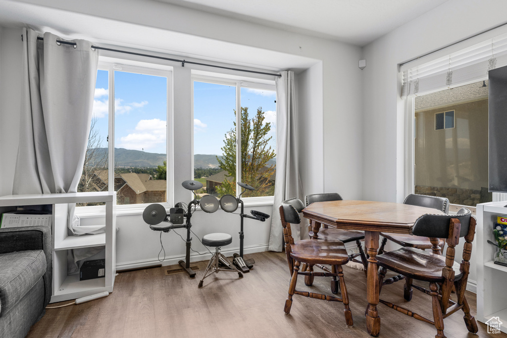 Dining space with a mountain view and wood-type flooring