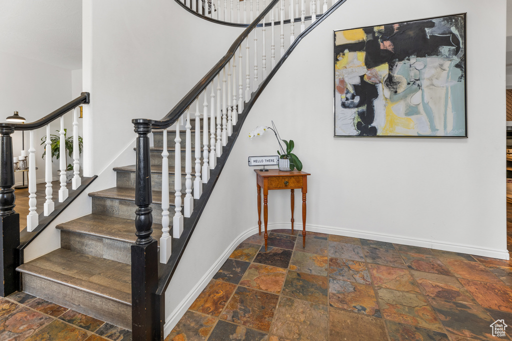 Stairs featuring dark tile patterned floors