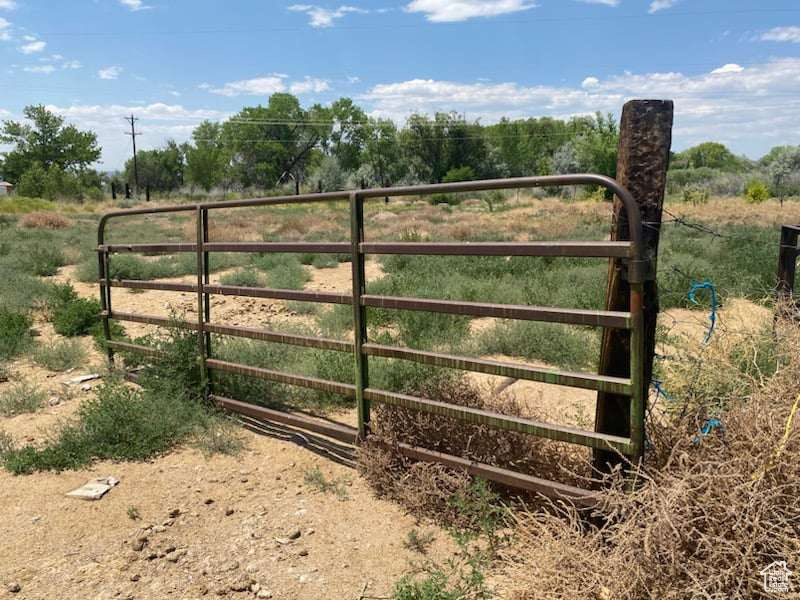 View of gate with a rural view