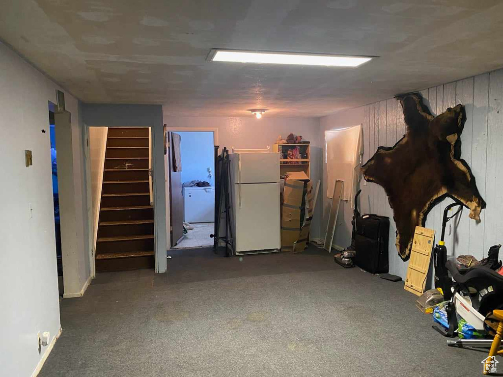 Basement featuring white fridge