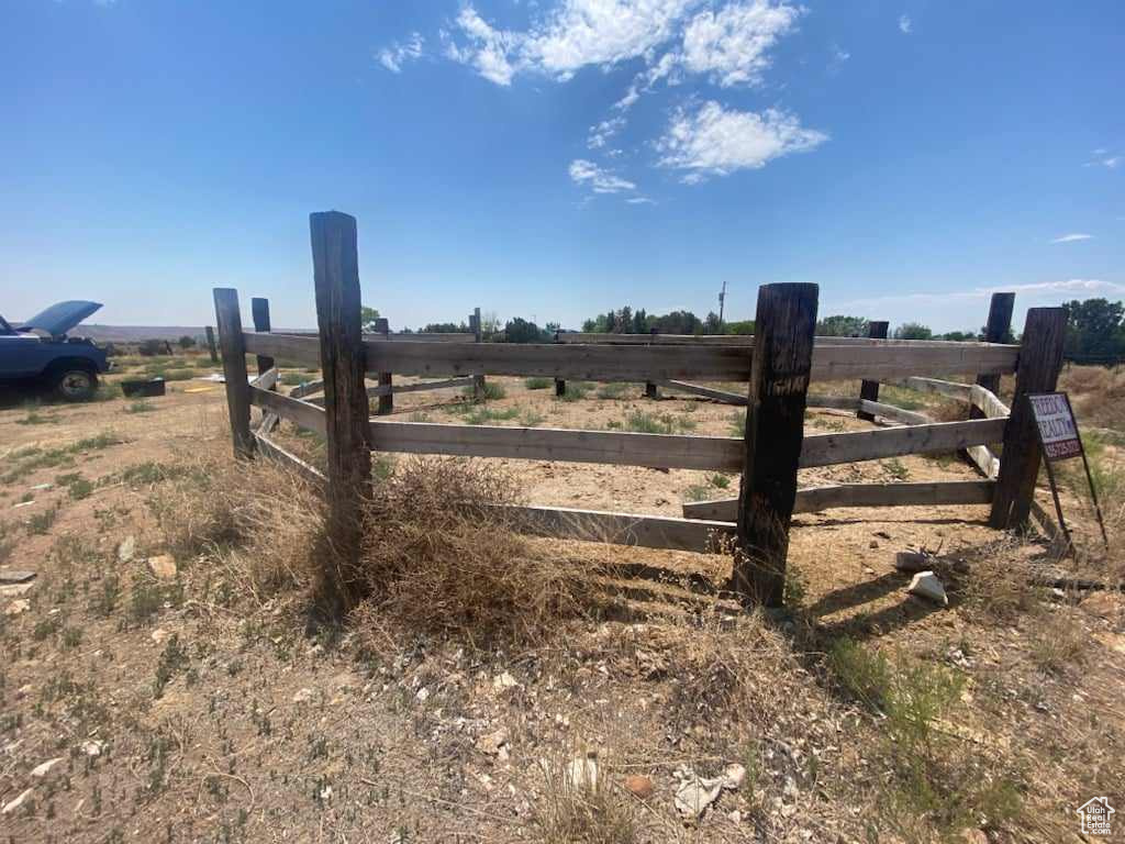 View of gate with a rural view