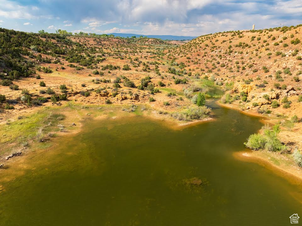 Birds eye view of property with a water view