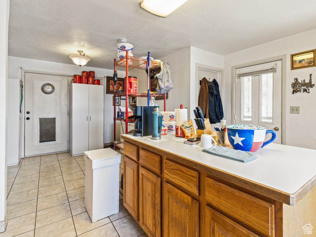 Kitchen featuring a center island and light tile patterned floors