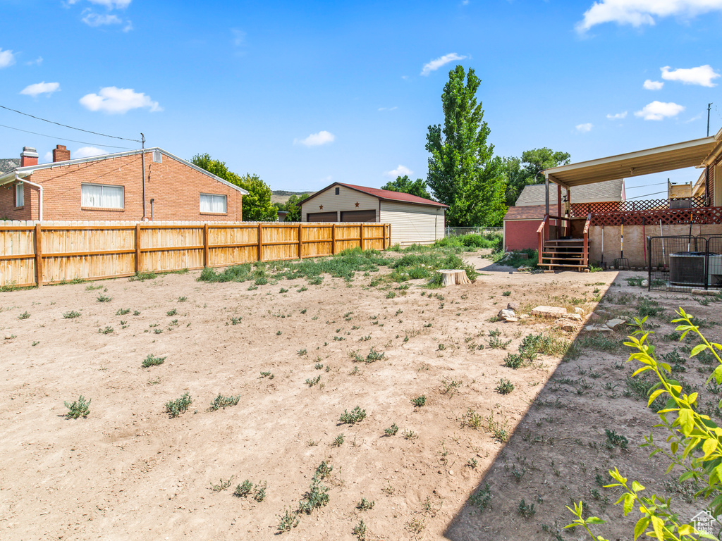 View of yard featuring a wooden deck and cooling unit