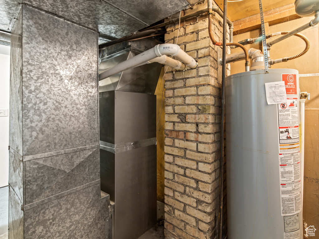 Utility room featuring water heater