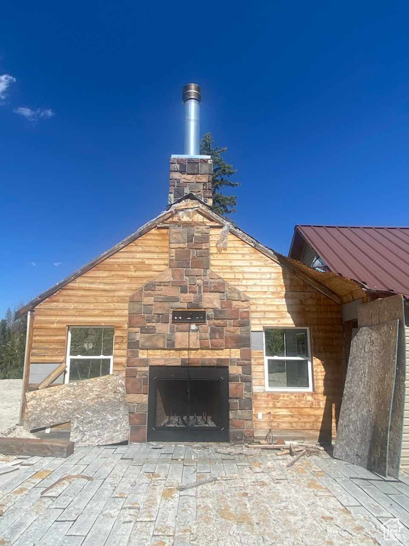 Exterior space with exterior fireplace and a patio area