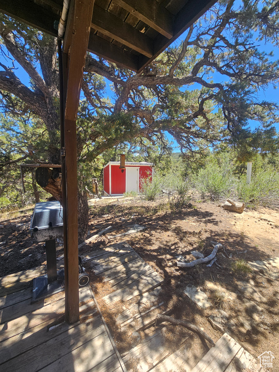 View of patio featuring a storage shed