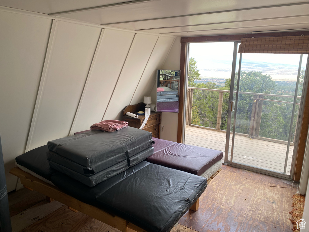 Bedroom with access to exterior and hardwood / wood-style floors