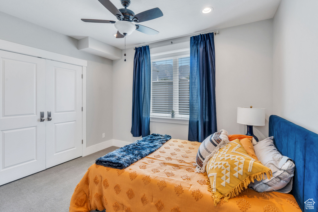 Bedroom featuring carpet flooring, a closet, and ceiling fan