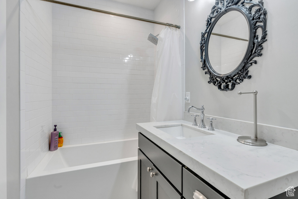 Bathroom with shower / tub combo with curtain and vanity