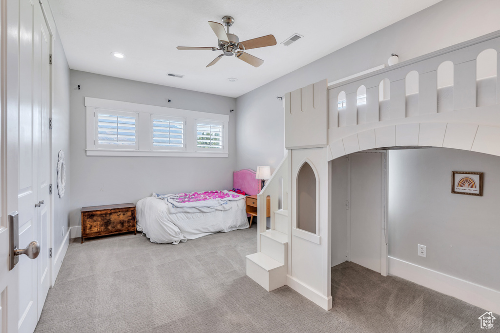 Bedroom with light carpet and ceiling fan