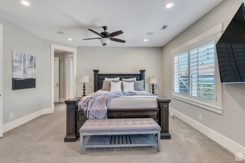 Bedroom featuring light carpet and ceiling fan