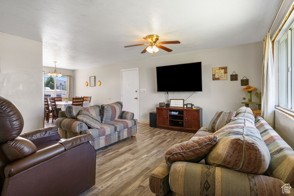 Living room featuring wood-type flooring, a wealth of natural light, and ceiling fan