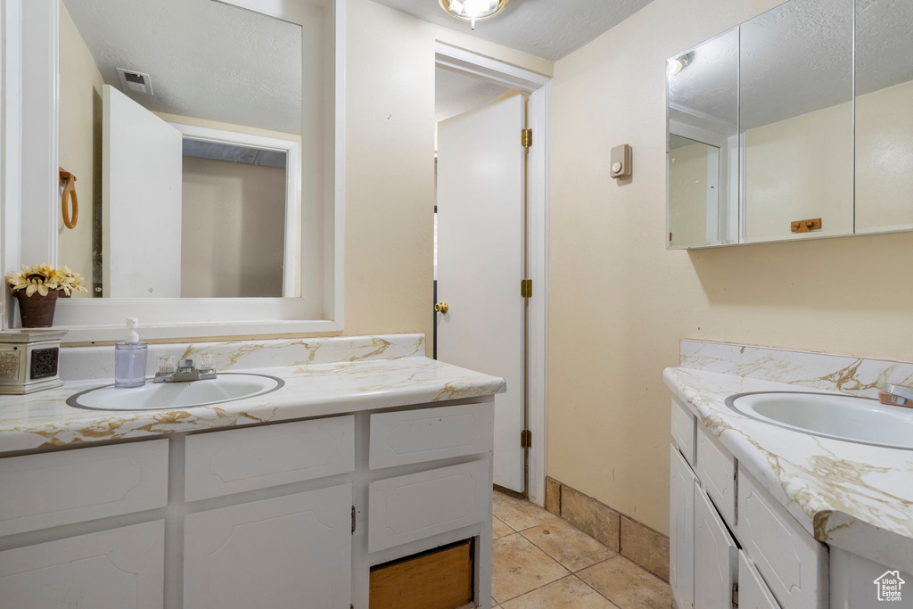 Bathroom with vanity and tile patterned floors