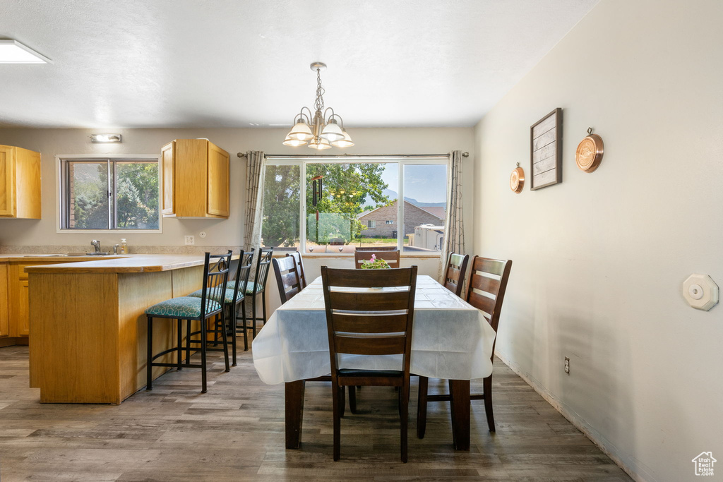 Dining room featuring hardwood / wood-style floors and a chandelier