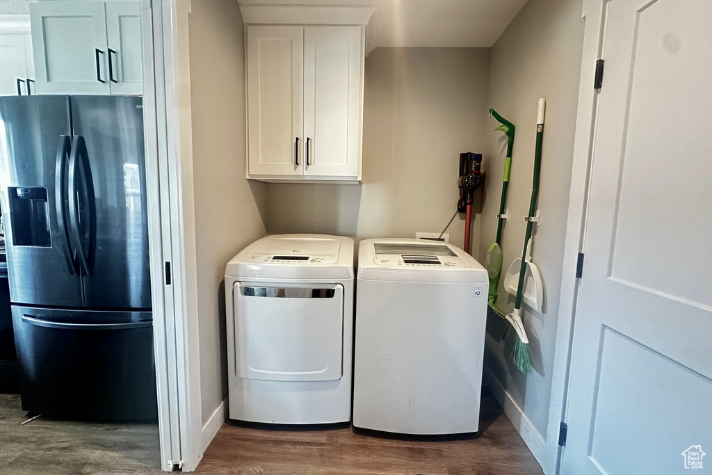 Washroom featuring separate washer and dryer and wood-type flooring