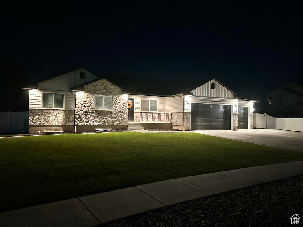 Craftsman house with a garage and a yard