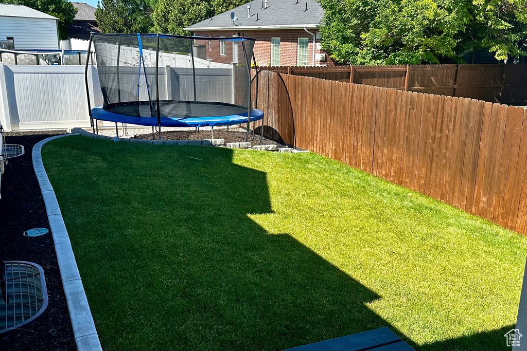 View of yard with a trampoline