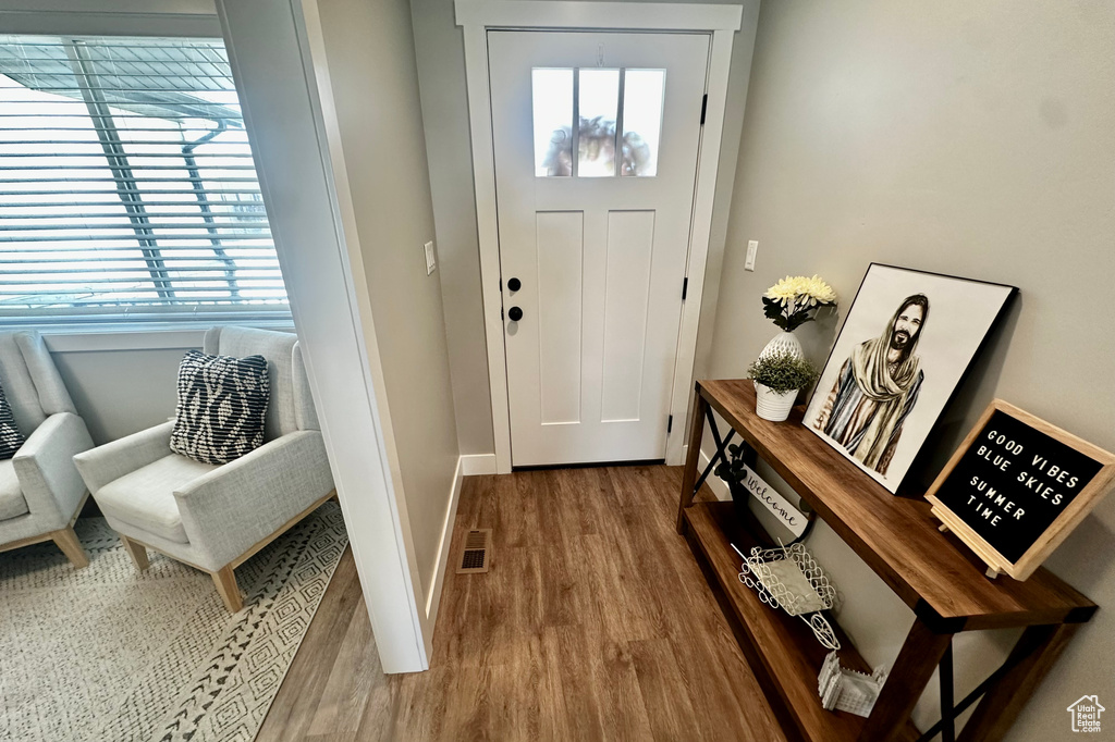 Entrance foyer with hardwood / wood-style floors