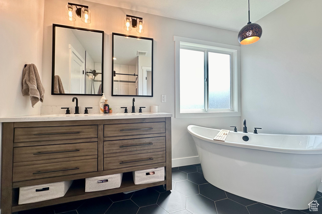 Bathroom featuring double vanity and tile patterned floors