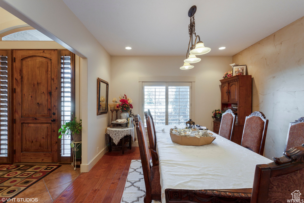 Dining space with dark hardwood / wood-style flooring