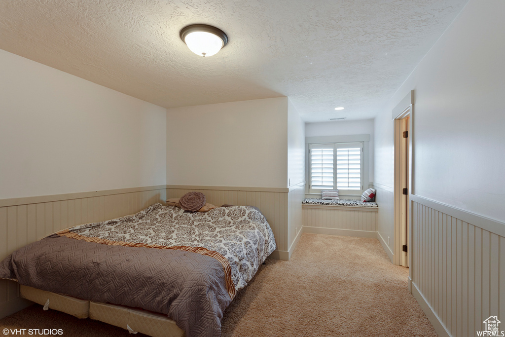 Carpeted bedroom featuring a textured ceiling